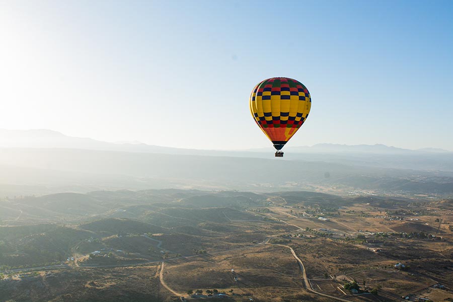 Contact - Hot Air Balloon Flying Over Temecula, California on a Misty Morning
