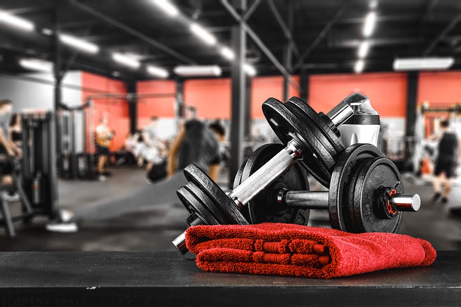 Specialized Business Insurance - A Fitness Center With Weights and a Red Towel on a Weight Bench